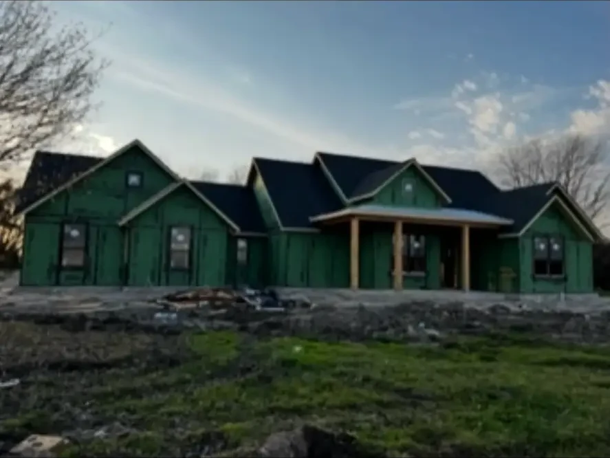 Front elevation of a custom home with multiple gables at the sheathing stage
