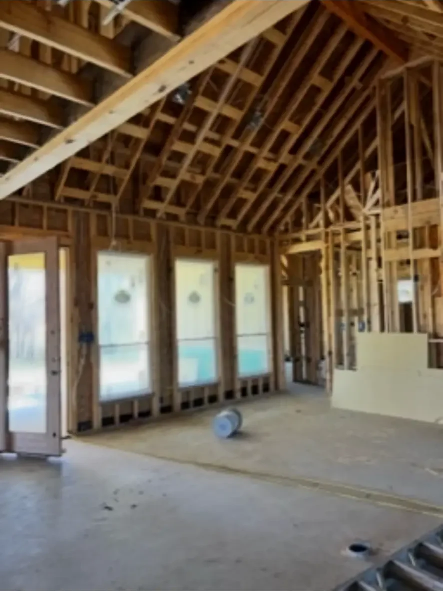Great room framing with a vaulted ceiling and a wall of window openings