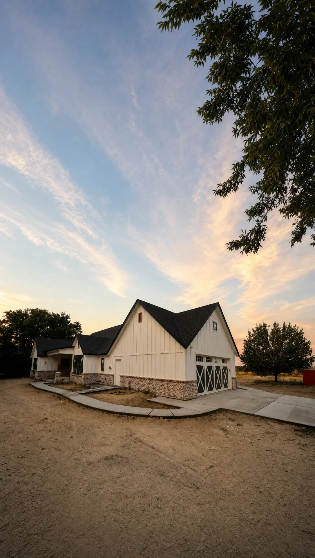 Side elevation of a finished custom home and garage on an open Northeast Texas lot