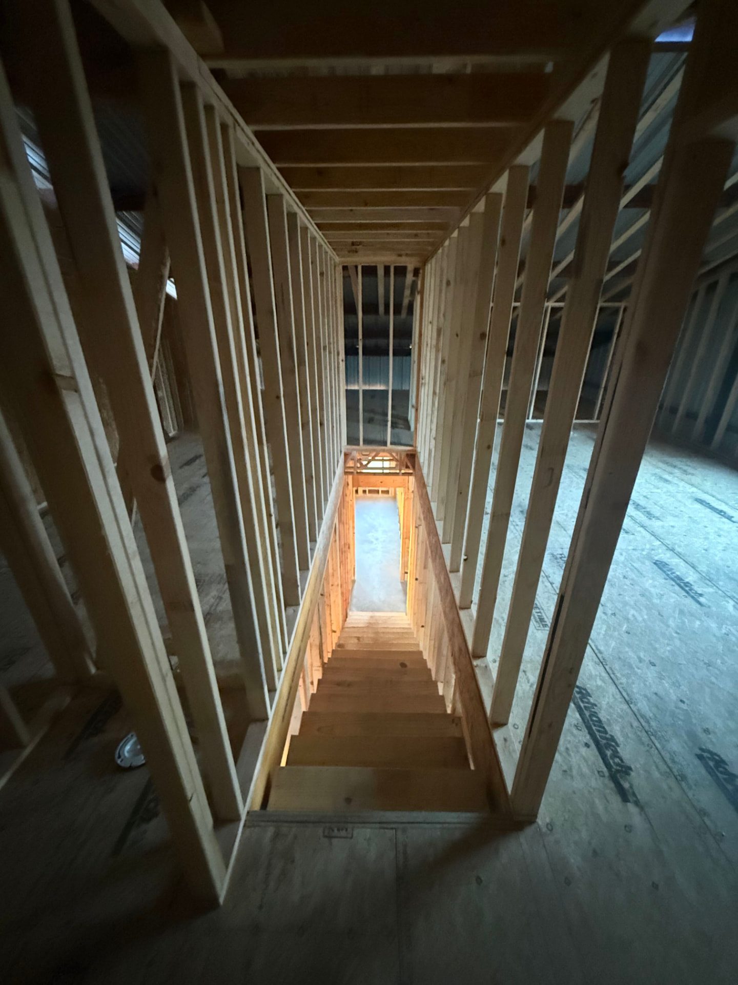 Framed stairwell viewed from the second floor of a barndominium under construction