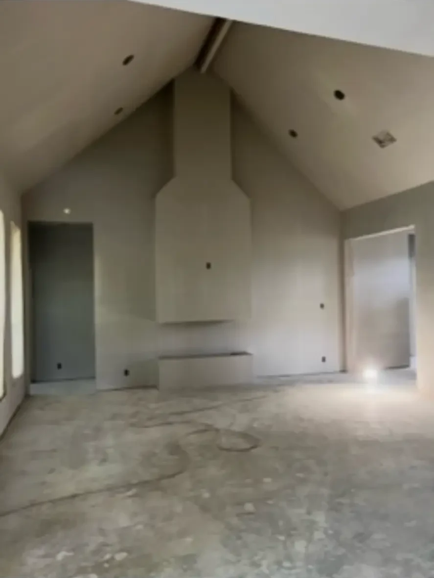 Vaulted great room at drywall stage with a framed fireplace chase